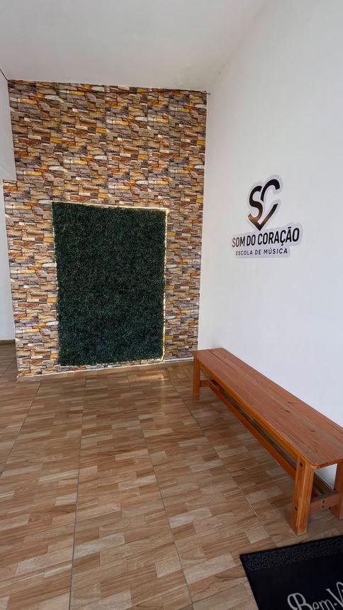 Recepção da escola com a logo do Som do Coração na parede